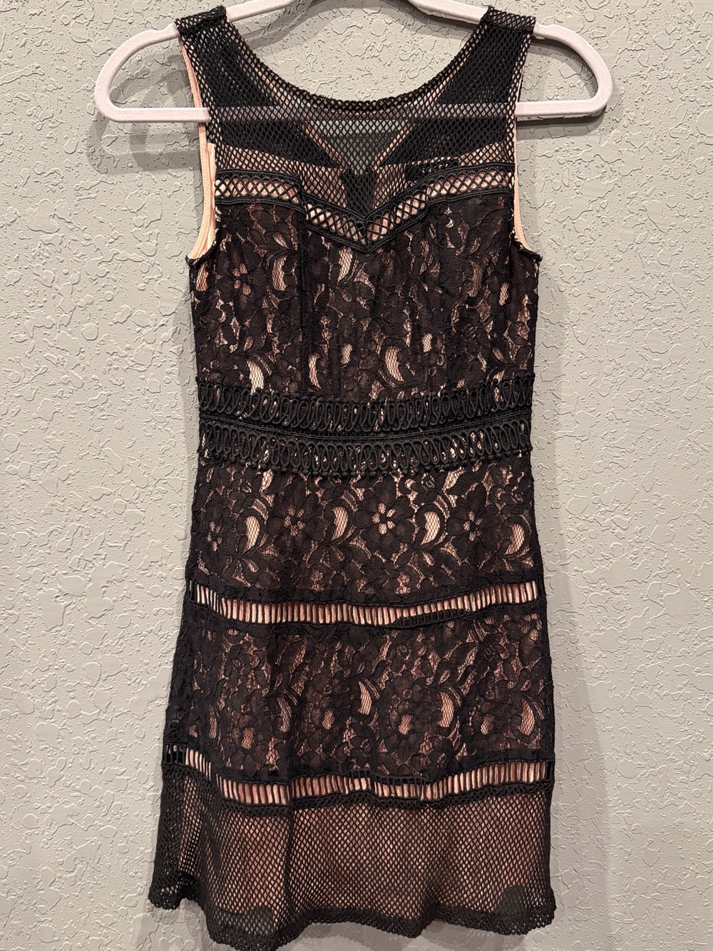 sleeveless black lace and fishnet overlay cocktail dress with blush lining